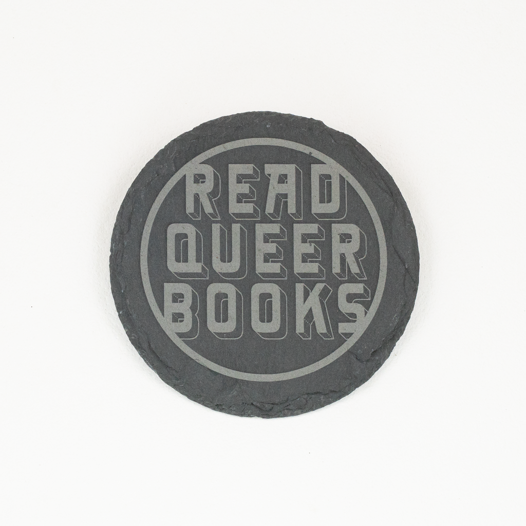 Single round slate coaster with 'Read Queer Books' engraved in stylized font within a circle.