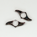 Two blades-shaped resin bookmarks with swirls of black and glitter.